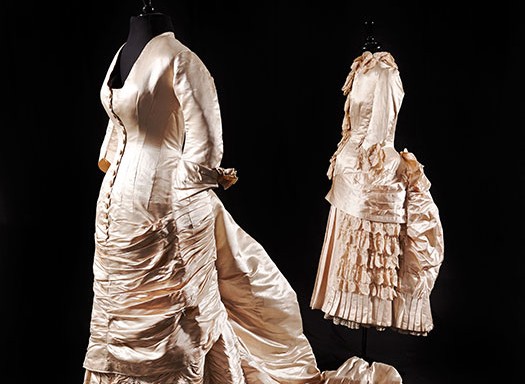 satin gown displayed with a rare child's bridesmaid dress.
Made by Farmer's
19th century.