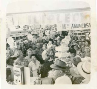 Philanthropist Phillip Leong holds his daughter Phillis aloft at his Food Store s 15th Anniversary Celebrations 1959 related image