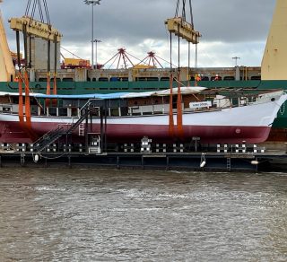 The Alma Doepel being lifted off her barge and returned to the water October 2021 related image