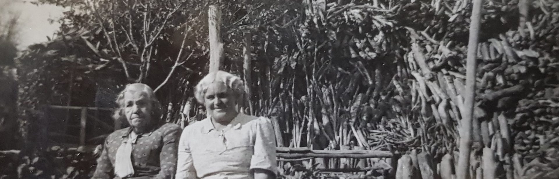 Rosanna Meech and daughter Gace with woodpile