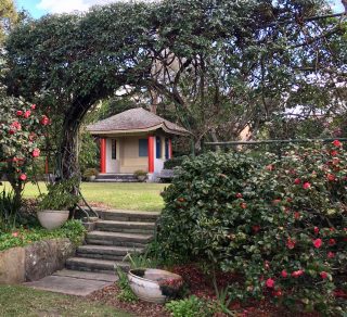 Garden view of oriental tea house through a circular gate at Eryldene Historic House and Garden related image