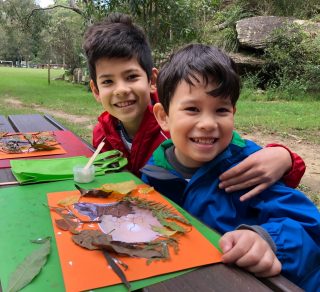 Two proud nature craft creators with their nature craft related image
