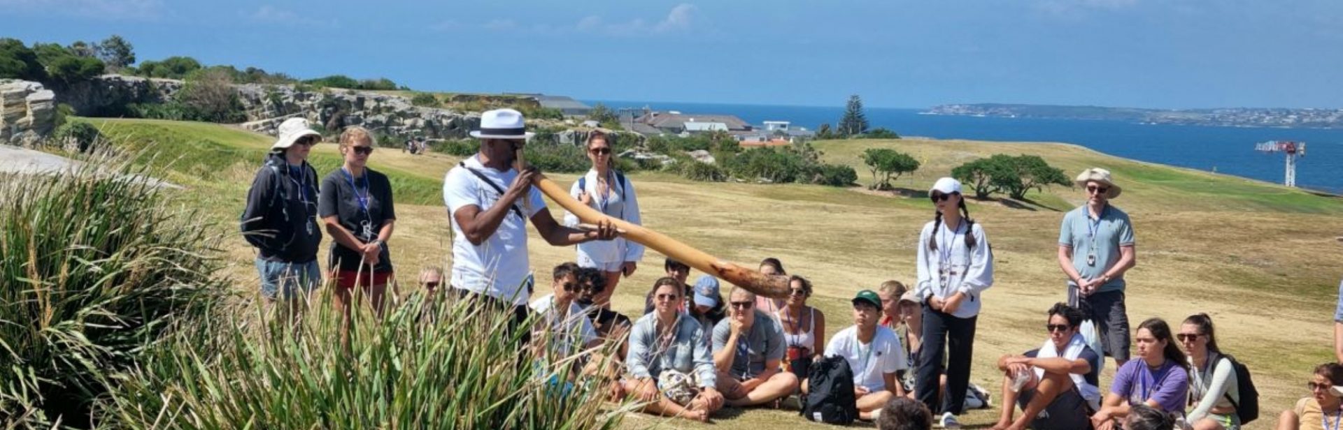 Walangari plays didgeridoo at the beginning of his Bondi Aboriginal Walking Tours