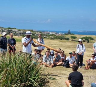 Walangari plays didgeridoo at the beginning of his Bondi Aboriginal Walking Tours related image
