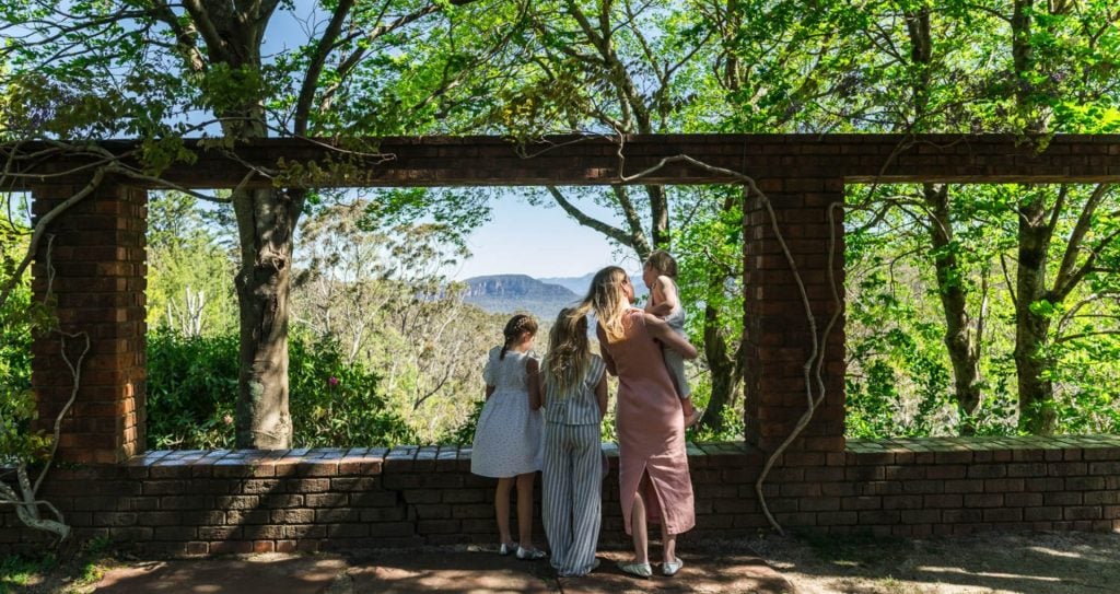 A family admire the view out over Jamison Valley at Everglades House & Gardens.