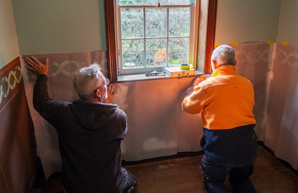 Meticulous re-stenciling being carried out at Harper's Mansion.