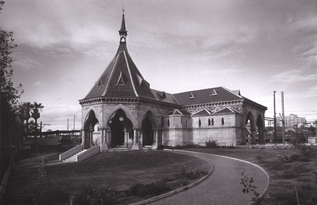 A gothic-inspired sandstone building with dramatic arches and ornate detailing.