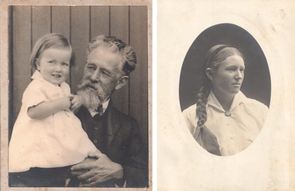 A man with a beard holds a young child in a dress in his arms. Right, a teenager with a long thick braid with a headband looks off camera.