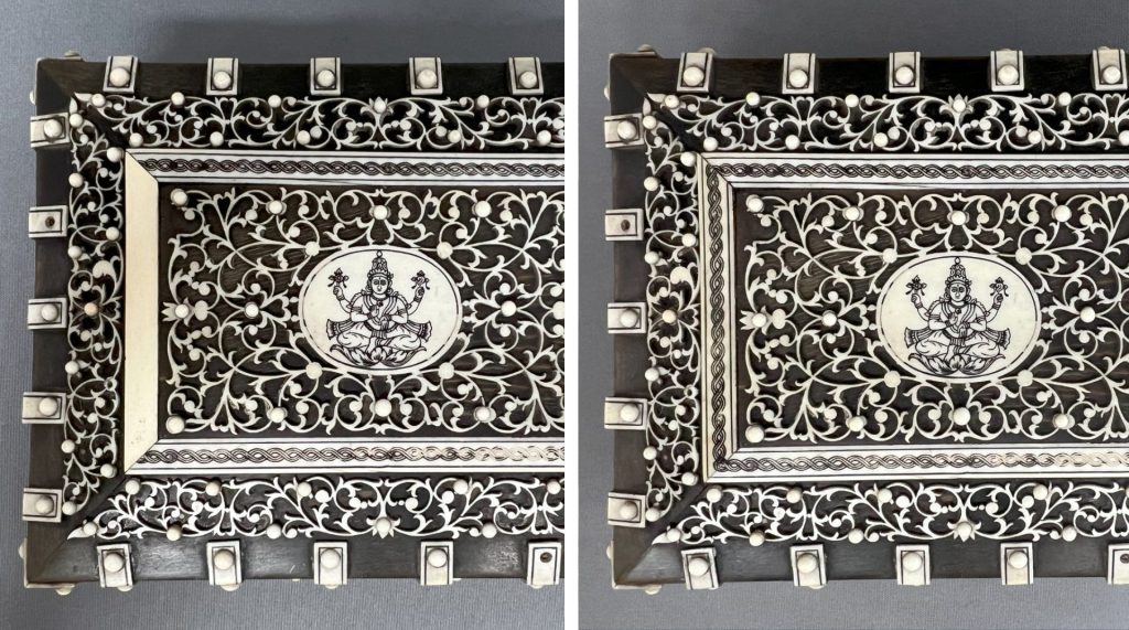 A restored antique trinket box made of dark wood and inlaid with a decorative finish of mother-of-pearl and ivory.