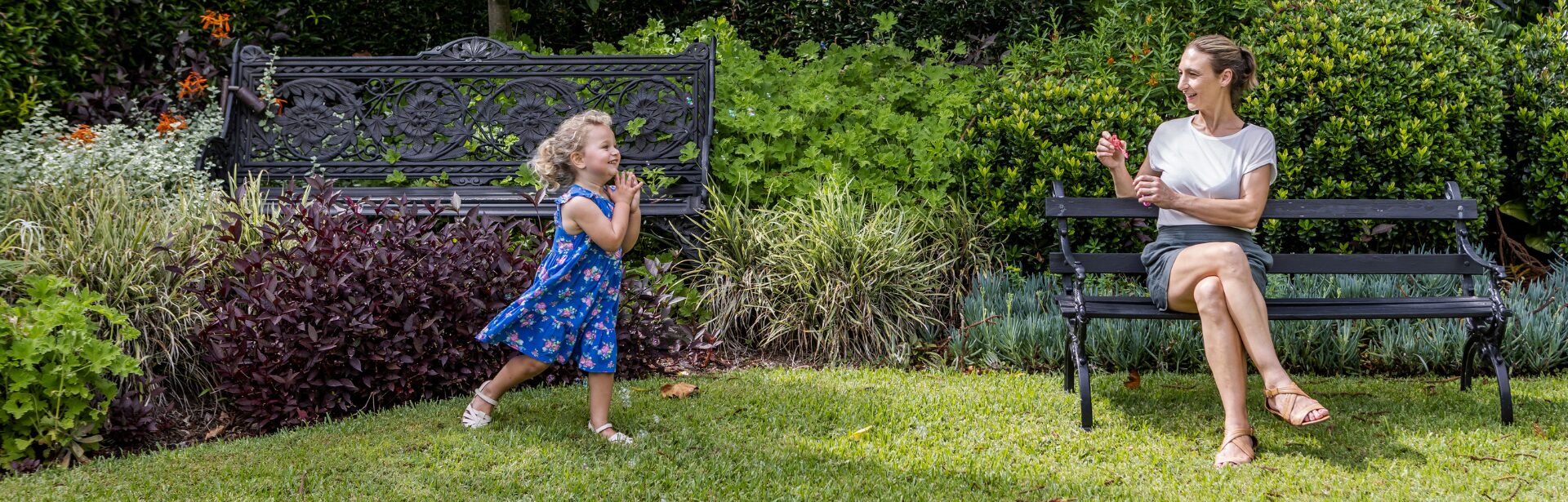 Lindesay Banner 1920 X 615 A child running to their mother in a green garden