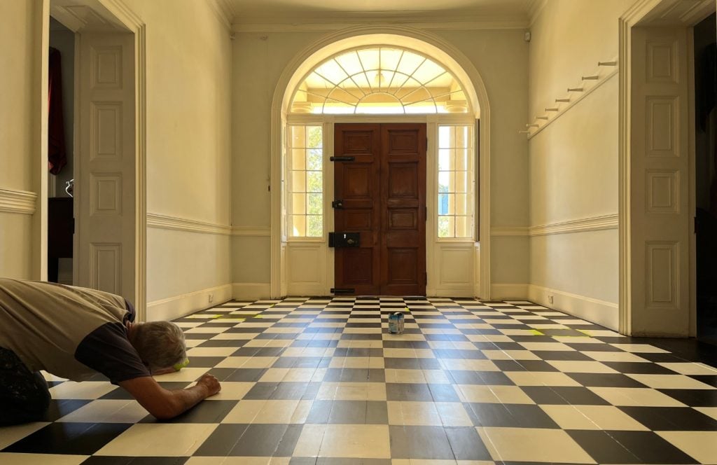 The black and white painted wooden floor of the foyer of Old Government House