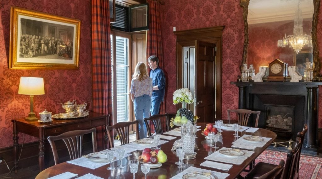 Visitors look out the window in the graceful dining room at Lindesay. 