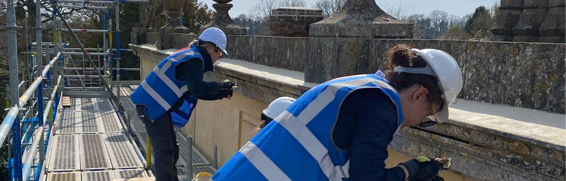 Scholars repointing a parapet