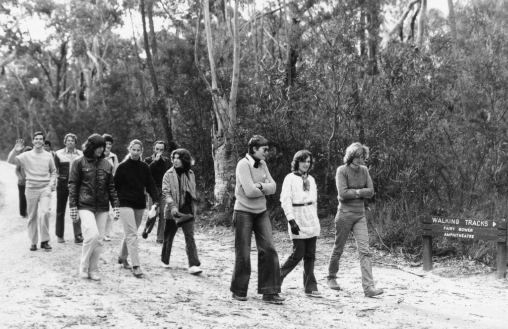 A black and white photograph of stylish young men and women in the sixties.